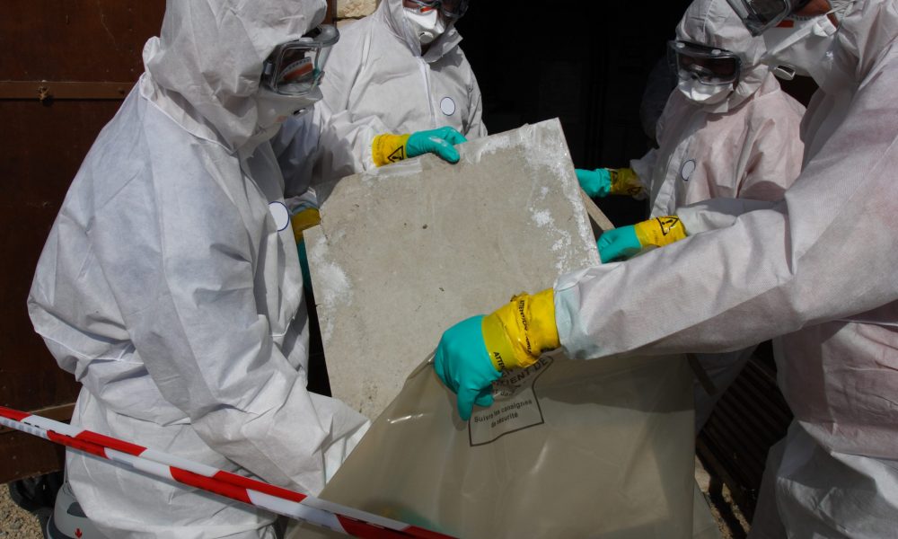 Staff removing some asbestos in a post of transformer